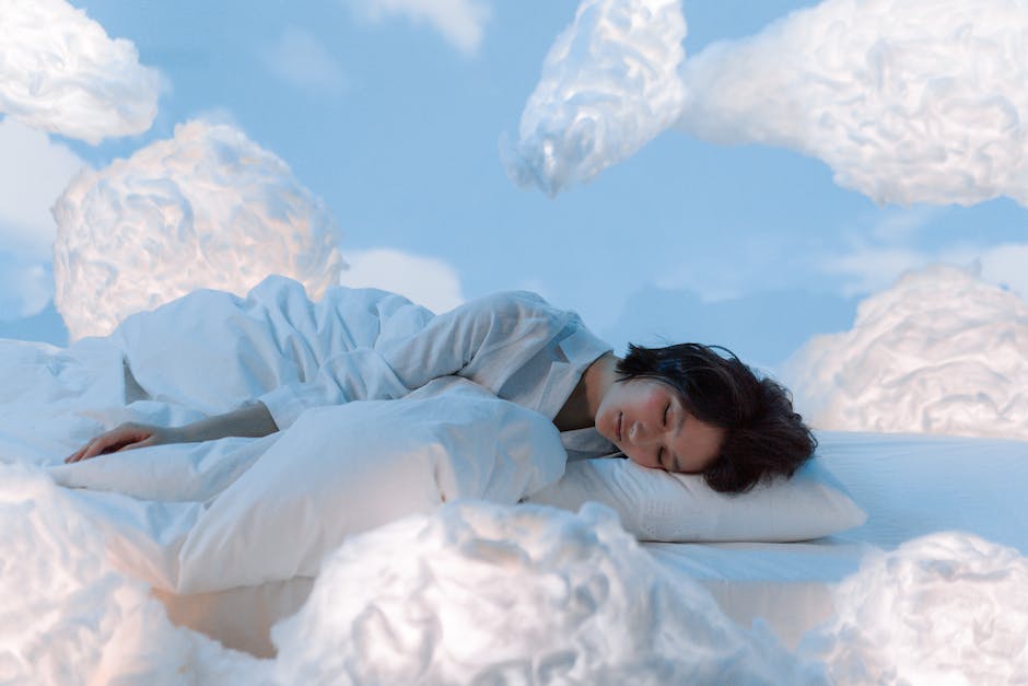 A person sleeping and dreaming in a bed, while various dream locations like mountains and cities float around them