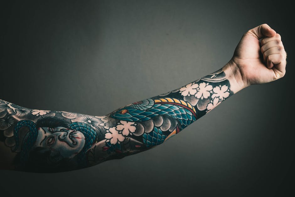 Image of a person with tattoos on their arms, representing the symbol of family in dreams and the significance it holds.