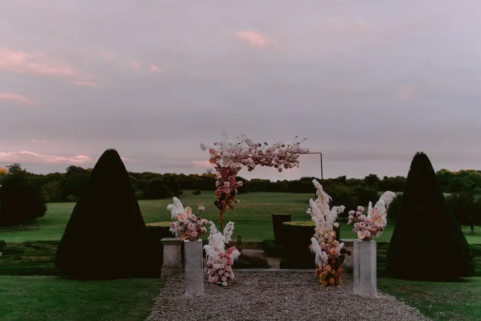 A photo of a bride and groom standing in front of an arch made of flowers